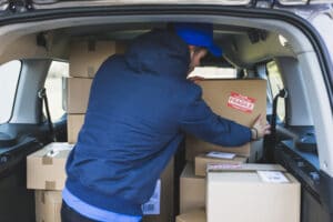 deliveryman-car-with-carton-boxes_23-2147767539