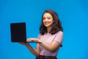 female-employee-with-black-laptop-having-video-call-while-looking-camera_114579-14888