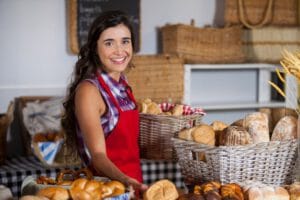 female-staff-holding-basket-sweet-foods-bakery-section_107420-92164