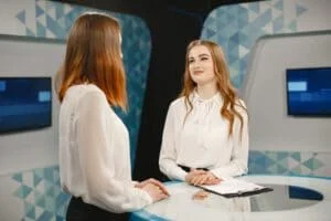 two-young-women-set-tv-interview-focus-women-tv-studio_1157-47916