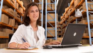 13253519 - female administrative in a desk with a distribution warehouse in the background