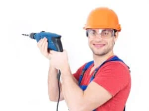 portrait-smiling-man-drilling-hole-wall_186202-3074