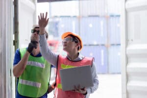 working audit engineer team in shipping harbor port checking goods cargo container strength test for safety and security by Intermodal containers standard.